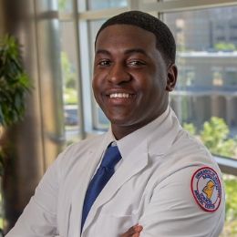 Male radiologic sciences student smiles while posing in the school of health related professions building.
